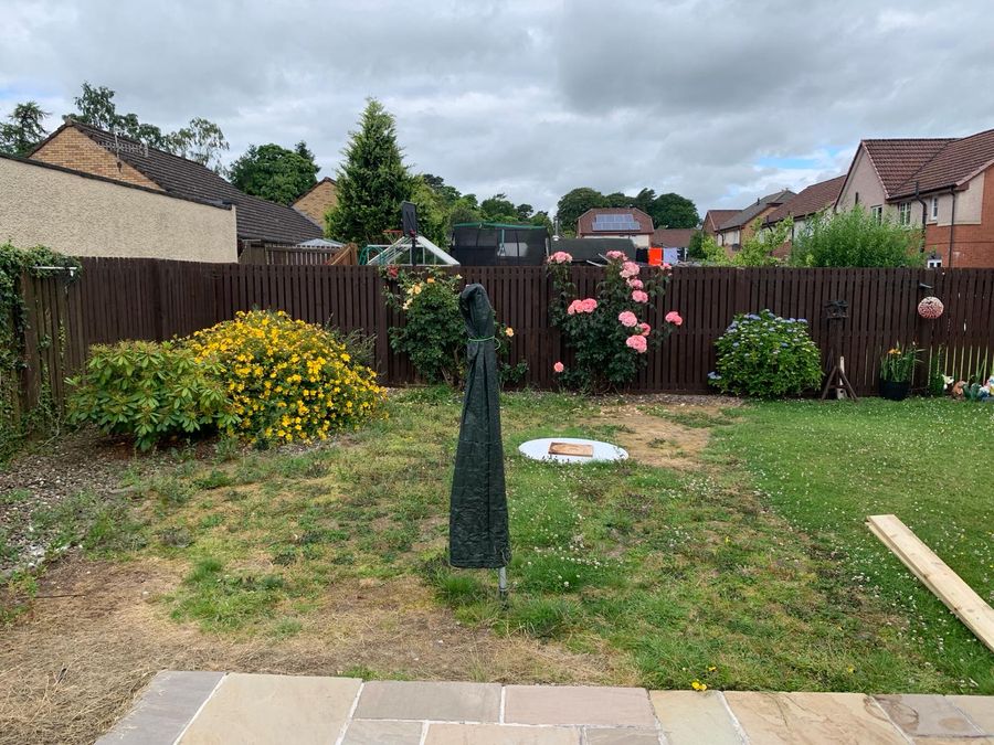 Overgrown lawn before gravel landscaping in Dundee